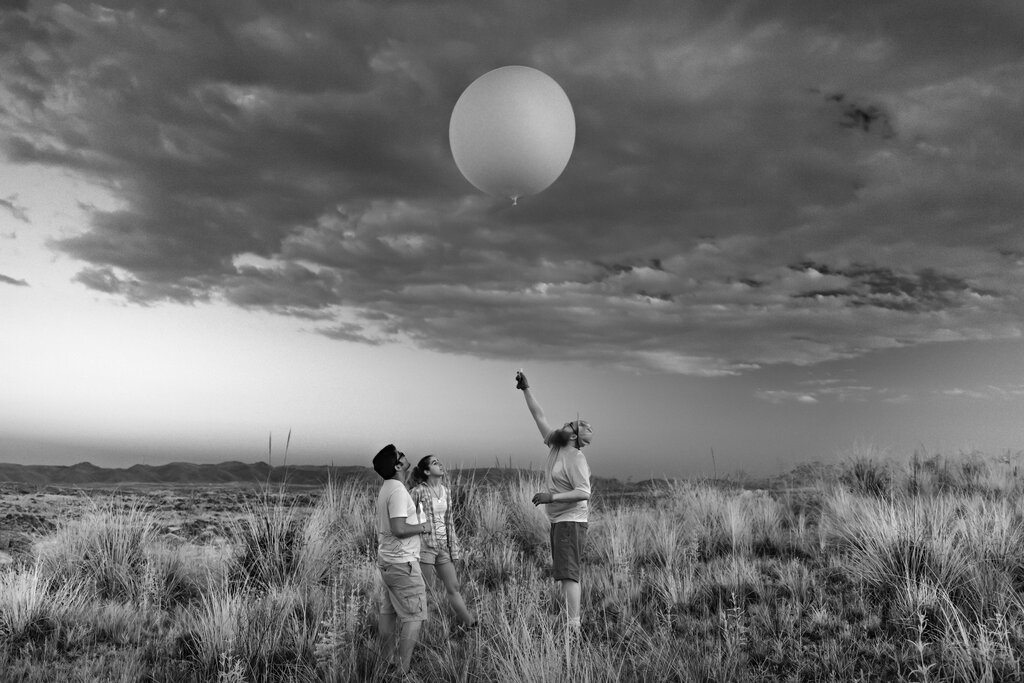 Graduate students launch a weather balloon, or a ‘‘sounding,’’ in the foothills of the Sierras de Córdoba, in central Argentina.